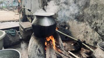 Traditional cooking method at a village using a firewood photo