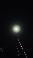Clear night view of a tallest post light placed in front of the largest apartment photo