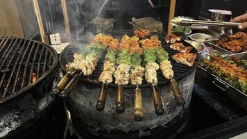 Mixture of spices on meat getting heated in the grill photo