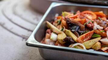 Close-up view of sweet and sour stir fry filled with pork pieces. photo