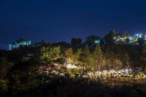 The view of twinkling lights from the many residential houses nestled on hills. photo