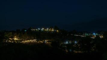 The view of twinkling lights from the many residential houses nestled on hills. photo