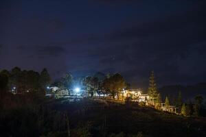 The view of twinkling lights from the many residential houses nestled on hills. photo