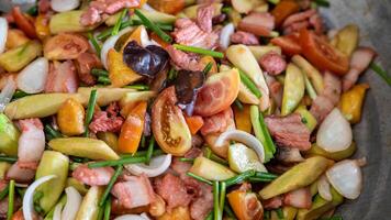 Close-up view of the background of sweet and sour stir-fry, consisting of pork pieces. photo