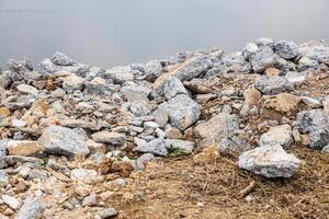 Piles of broken concrete debris taken from road demolition are left on a mound. photo