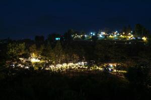The view of twinkling lights from the many residential houses nestled on hills. photo