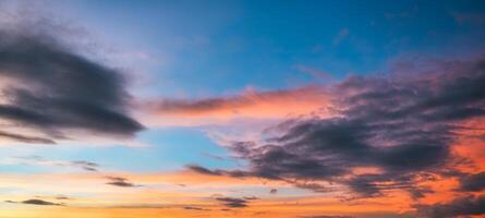 Beautiful dramatic colorful sky and cloud during golden hour at the sunset photo