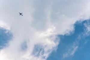 Airplane flying in the sky with white clouds photo