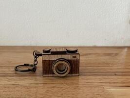 retro camera with old film on wooden table background. photo