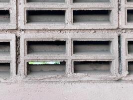 old brick wall with a lot of bricks with hole photo