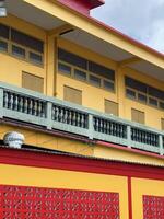 red and yellow building in city photo