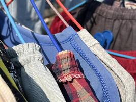 a closeup of colorful clothes on a rope photo