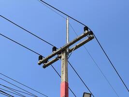 electricity pole with blue sky and clouds background photo