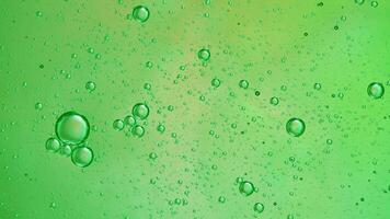 Abstract green colorful background with oil on water surface. Oil drops in water abstract psychedelic, abstract image. photo
