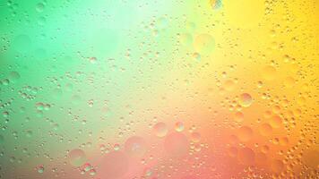 Abstract yellow, green and pink colorful background with oil on water surface. Oil drops in water abstract psychedelic, abstract image. photo