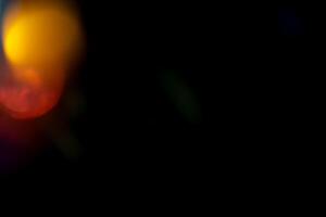 Multicolored highlights on a black background. for overlay to create a festive, vibrant effect photo