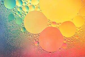 Abstract yellow, green and pink colorful background with oil on water surface. Oil drops in water abstract psychedelic, abstract image. photo
