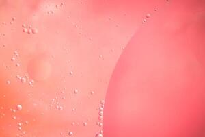 Abstract pink colorful background with oil on water surface. Oil drops in water abstract psychedelic, abstract image. photo