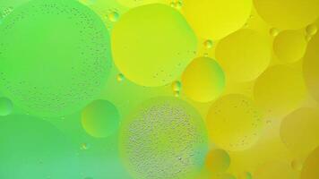 Abstract yellow and green colorful background with oil on water surface. Oil drops in water abstract psychedelic, abstract image. photo