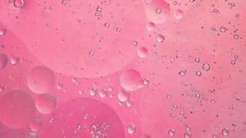 Abstract pink colorful background with oil on water surface. Oil drops in water abstract psychedelic, abstract image. photo