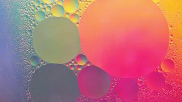 Abstract yellow, green and pink colorful background with oil on water surface. Oil drops in water abstract psychedelic, abstract image. photo