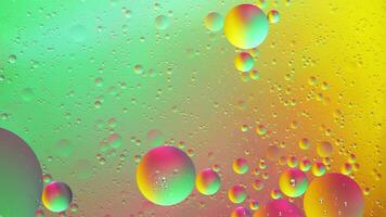 Abstract yellow, green and pink colorful background with oil on water surface. Oil drops in water abstract psychedelic, abstract image. photo
