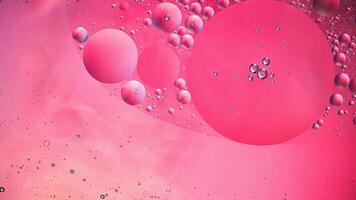 Abstract pink colorful background with oil on water surface. Oil drops in water abstract psychedelic, abstract image. photo