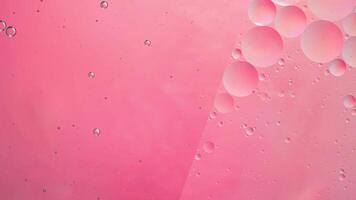 Abstract pink colorful background with oil on water surface. Oil drops in water abstract psychedelic, abstract image. photo