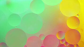 Abstract yellow, green and pink colorful background with oil on water surface. Oil drops in water abstract psychedelic, abstract image. photo