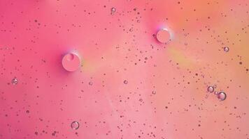 Abstract pink colorful background with oil on water surface. Oil drops in water abstract psychedelic, abstract image. photo