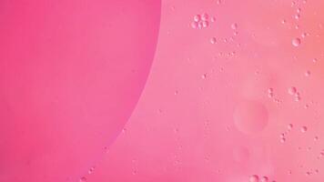 Abstract pink colorful background with oil on water surface. Oil drops in water abstract psychedelic, abstract image. photo