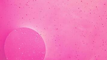 Abstract pink colorful background with oil on water surface. Oil drops in water abstract psychedelic, abstract image. photo