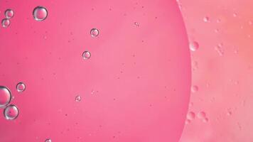 Abstract pink colorful background with oil on water surface. Oil drops in water abstract psychedelic, abstract image. photo