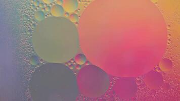 Abstract yellow, green and pink colorful background with oil on water surface. Oil drops in water abstract psychedelic, abstract image. photo