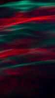 Defocused abstract red and green background of speed camera movement over glowing lights. A pattern of flashes of light similar to the northern lights photo