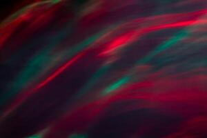 Defocused abstract red and green background of speed camera movement over glowing lights. A pattern of flashes of light similar to the northern lights photo