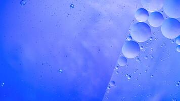 Abstract blue colorful background with oil on water surface. Oil drops in water abstract psychedelic, abstract image. photo