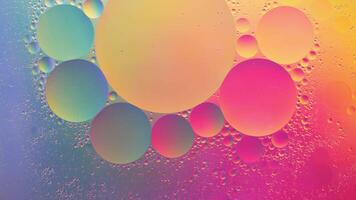 Abstract yellow, green and pink colorful background with oil on water surface. Oil drops in water abstract psychedelic, abstract image. photo