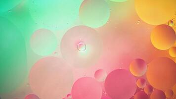 Abstract yellow, green and pink colorful background with oil on water surface. Oil drops in water abstract psychedelic, abstract image. photo