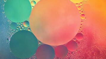 Abstract yellow, green and pink colorful background with oil on water surface. Oil drops in water abstract psychedelic, abstract image. photo