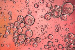 Abstract pink colorful background with oil on water surface. Oil drops in water abstract psychedelic, abstract image. photo