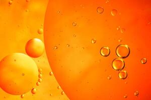 Abstract orange colorful background with oil on water surface. Oil drops in water abstract psychedelic, abstract image. photo