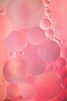 Abstract pink colorful background with oil on water surface. Oil drops in water abstract psychedelic, abstract image. photo