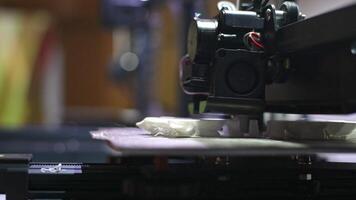 A 3D printer prints a model from white plastic. modern technologies, 3D modeling photo