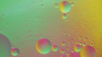 Abstract yellow, green and pink colorful background with oil on water surface. Oil drops in water abstract psychedelic, abstract image. photo