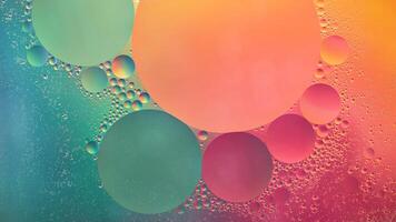 Abstract yellow, green and pink colorful background with oil on water surface. Oil drops in water abstract psychedelic, abstract image. photo