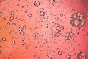 Abstract pink colorful background with oil on water surface. Oil drops in water abstract psychedelic, abstract image. photo