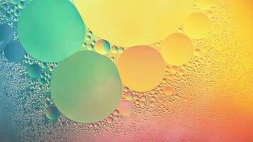 Abstract yellow, green and pink colorful background with oil on water surface. Oil drops in water abstract psychedelic, abstract image. photo