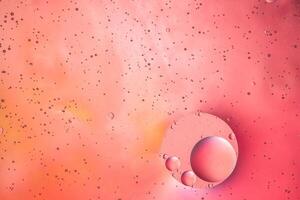 Abstract pink colorful background with oil on water surface. Oil drops in water abstract psychedelic, abstract image. photo