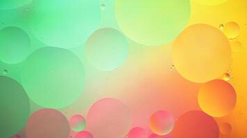 Abstract yellow, green and pink colorful background with oil on water surface. Oil drops in water abstract psychedelic, abstract image. photo